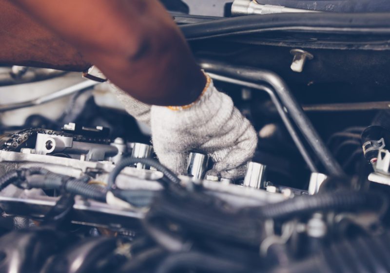 Hands of auto mechanic repairing car. Selective focus. Hands of auto mechanic repairing car. Selective focus.